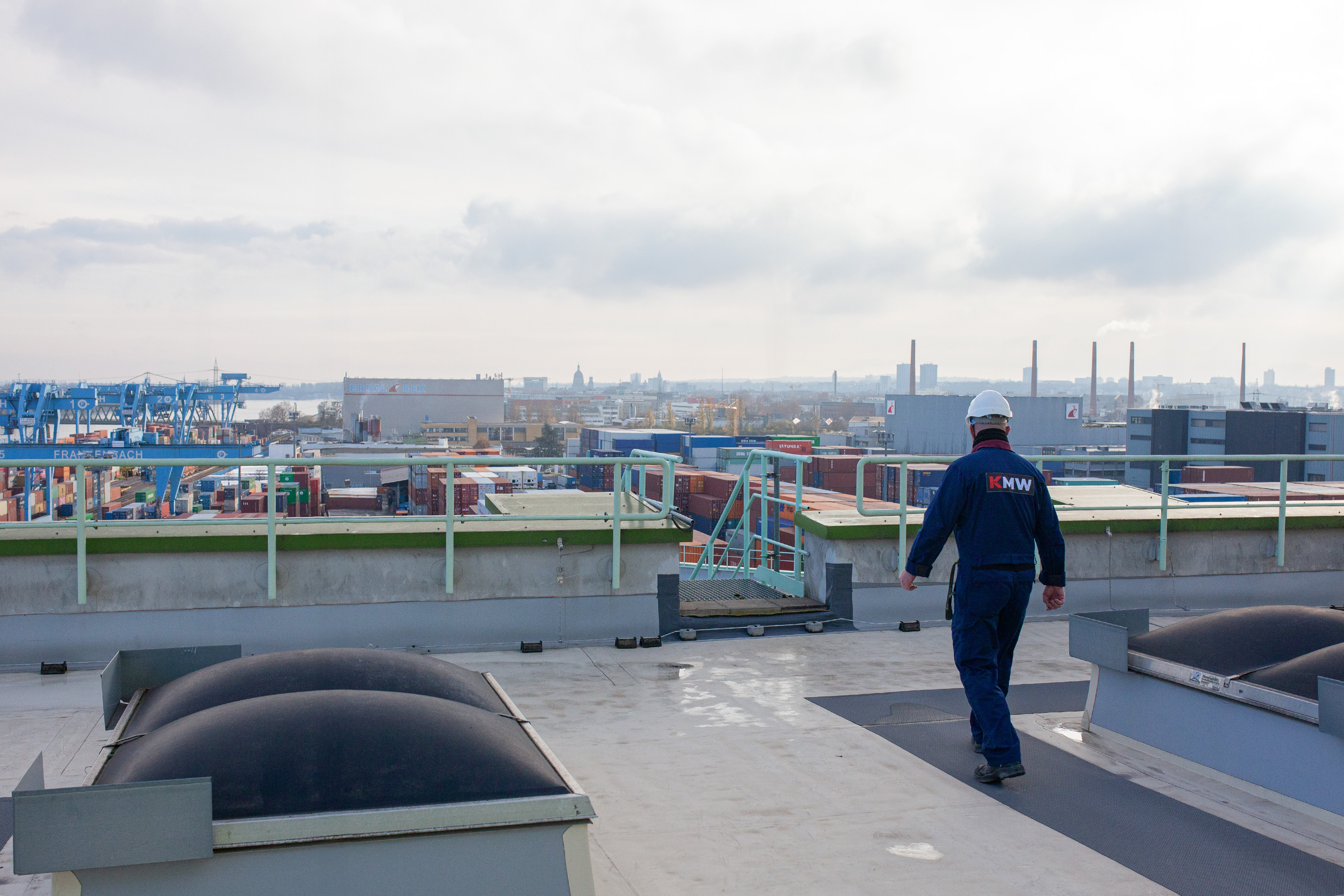 A man speaking into a microphone on an event. There are more people in the background