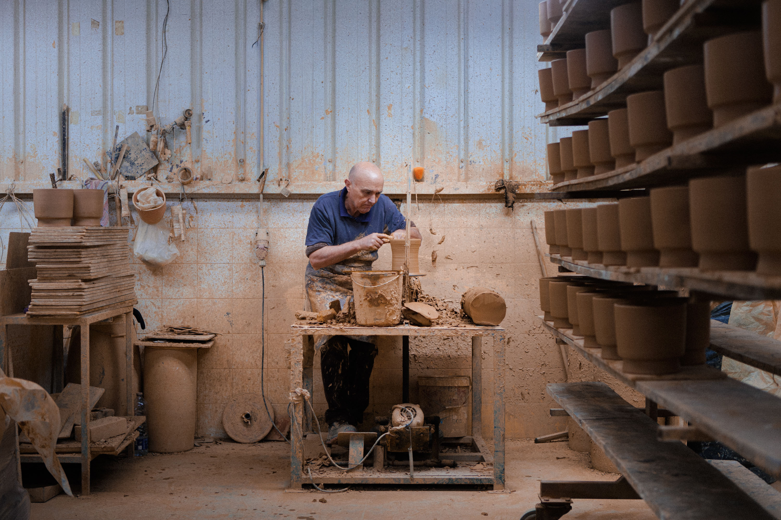 A man working on a ceramic turning table in Barcelos, Portugal