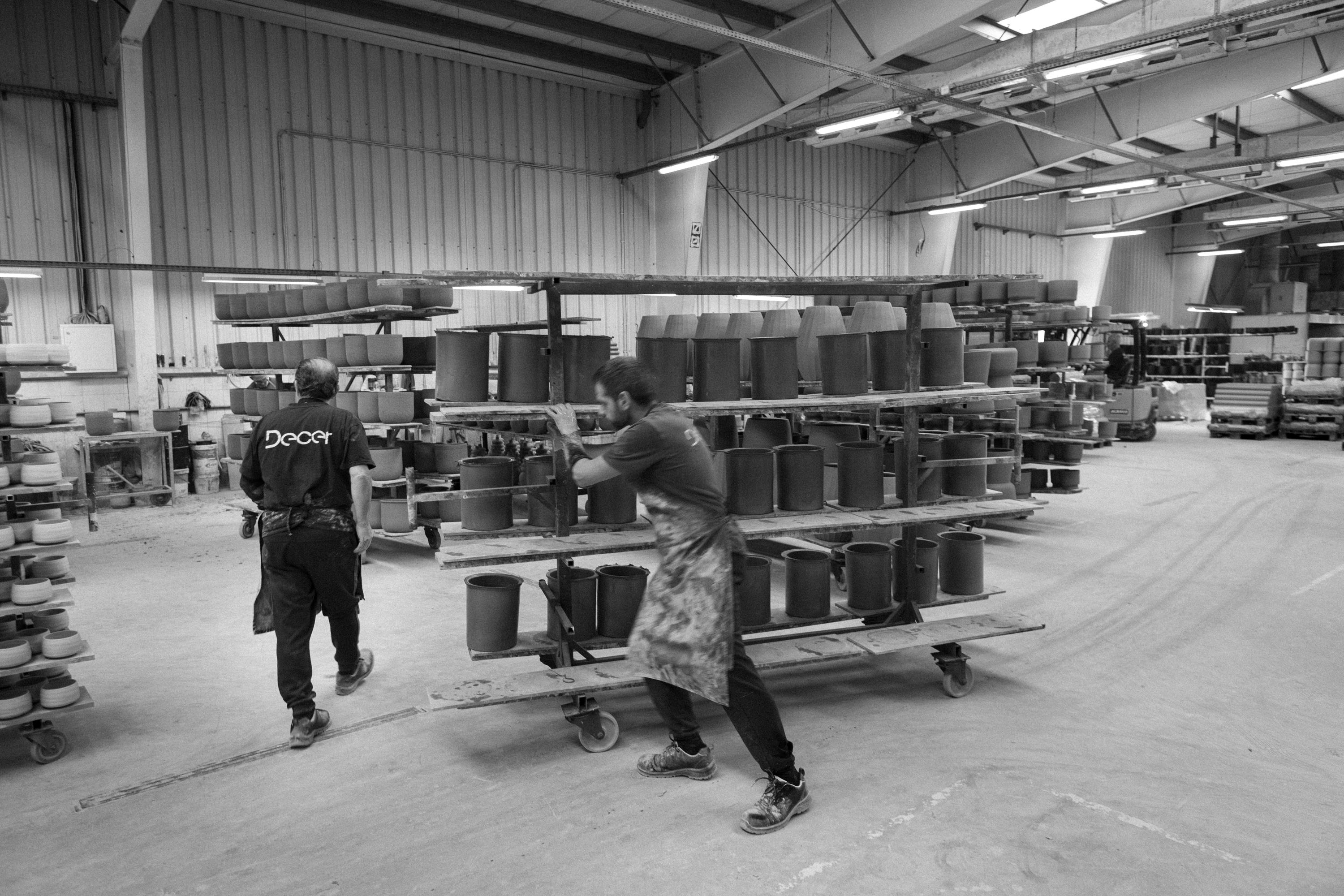 seven people sitting or standing in different groups are talking to each other