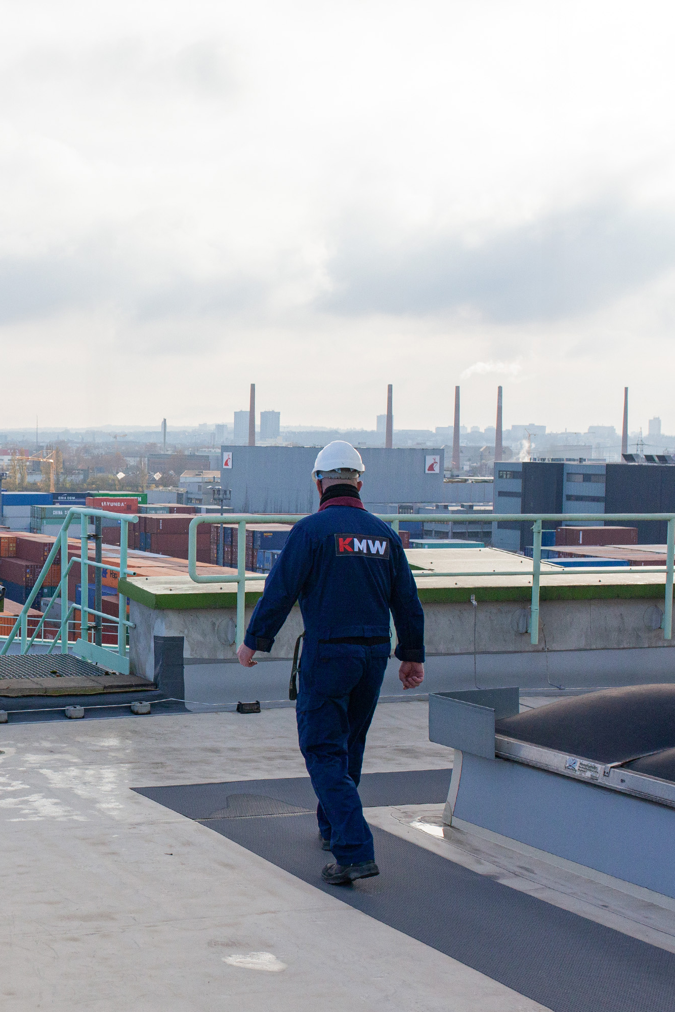 A man walking on a roof in an industrial area in Mainz, Germany
