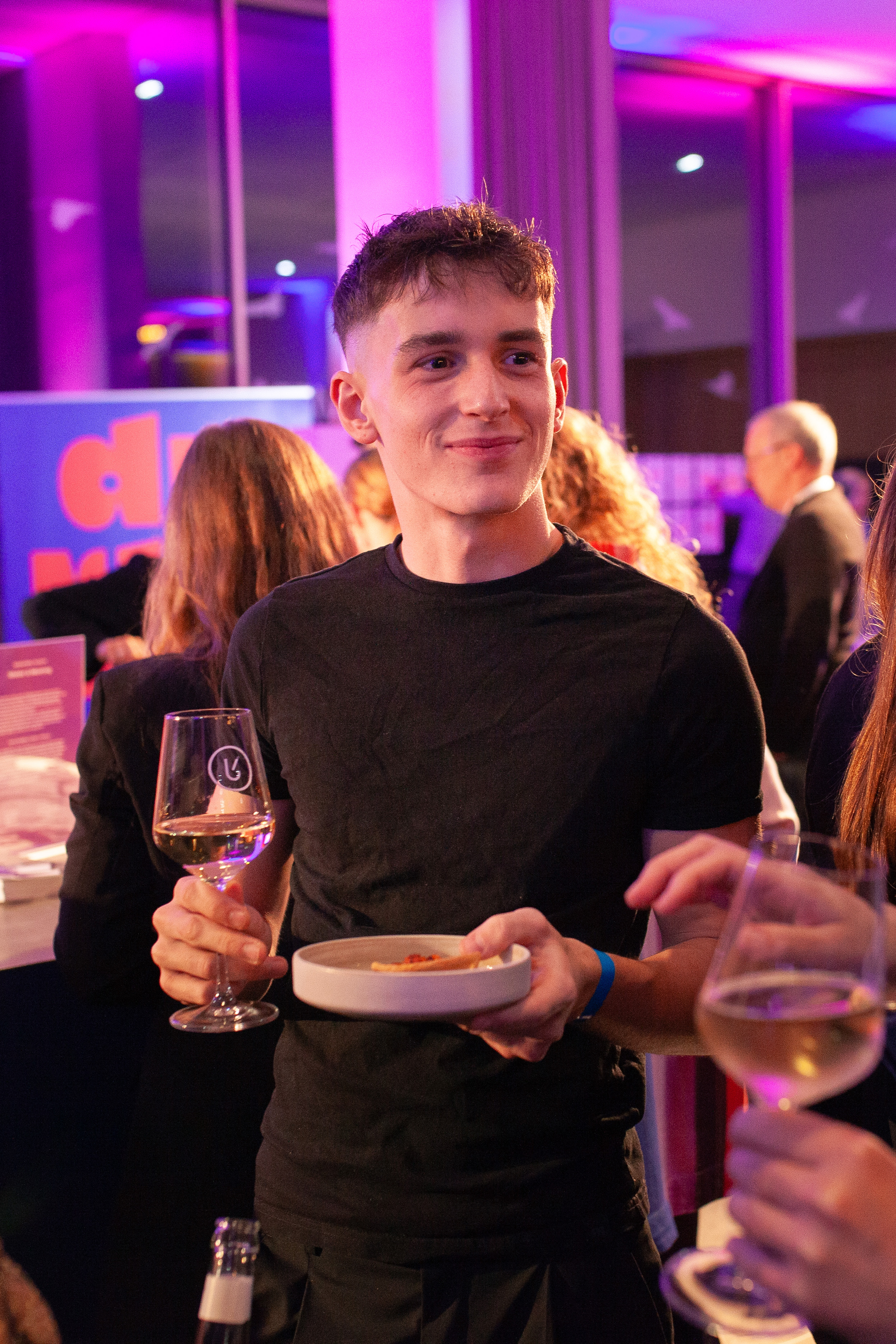 A young man with a glass of wine on an event in Mainz, Germany
