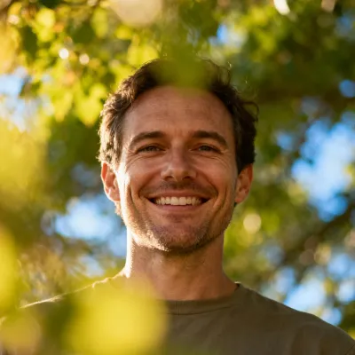 Smiling man outdoors, shown in BYQ Supply testimonial section.