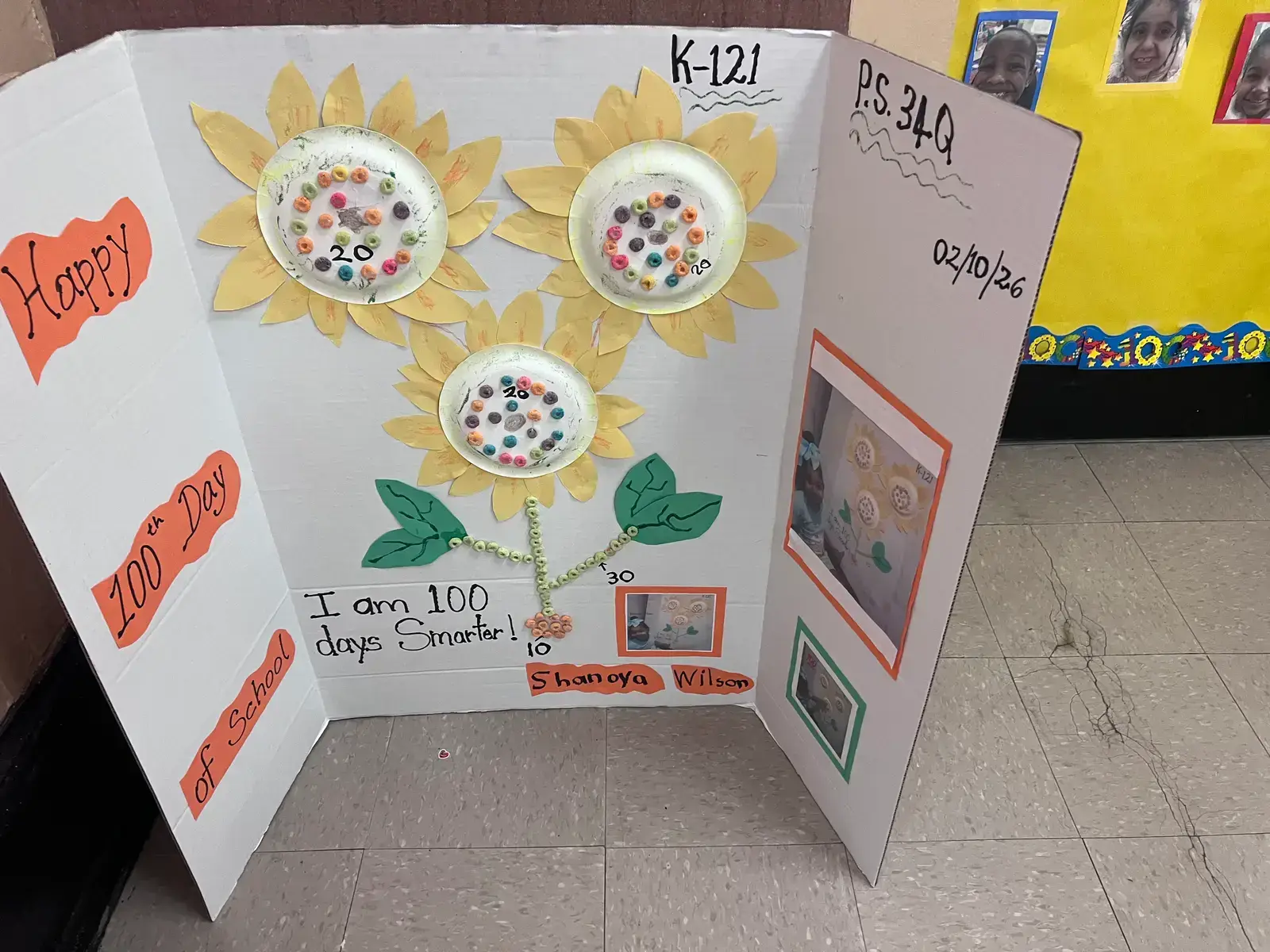 Student trifold poster celebrating 100th day of school with sunflower craft