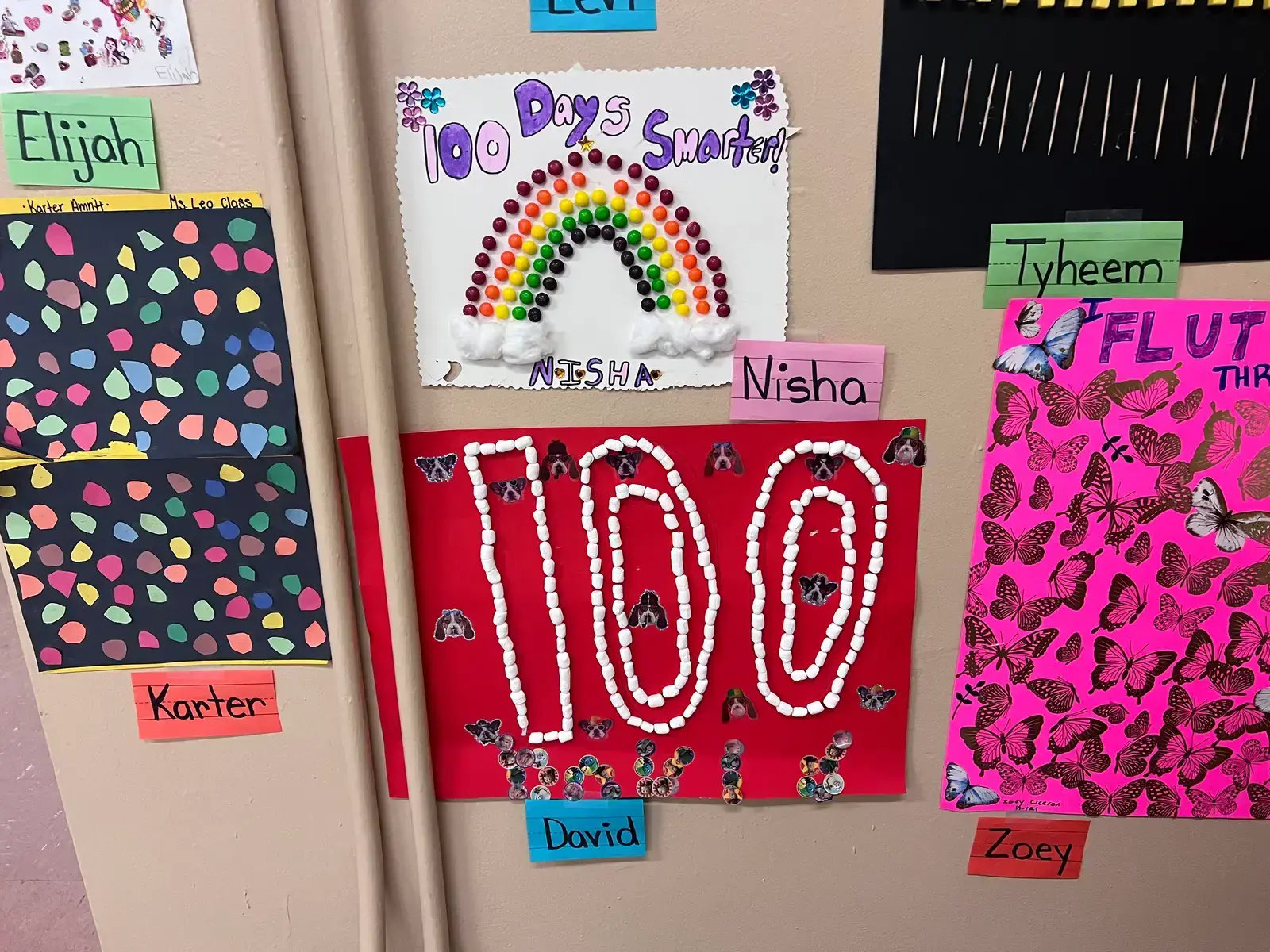 Student 100th Day of School projects displayed on classroom wall
