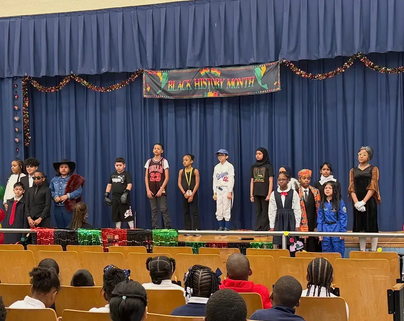 Students in costumes perform Black History Month play on school stage