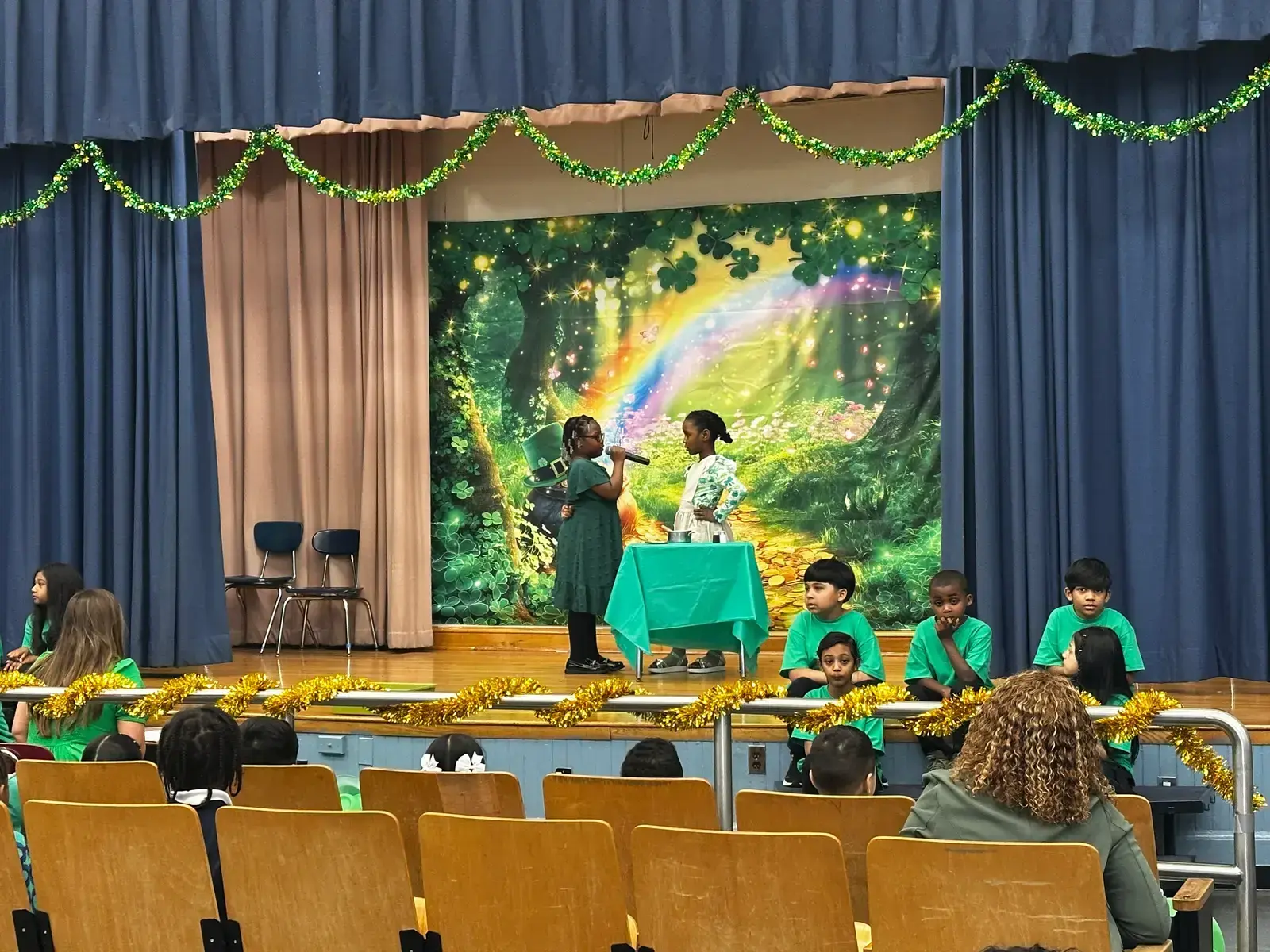 Students perform on stage during a Saint Patrick's Day school assembly