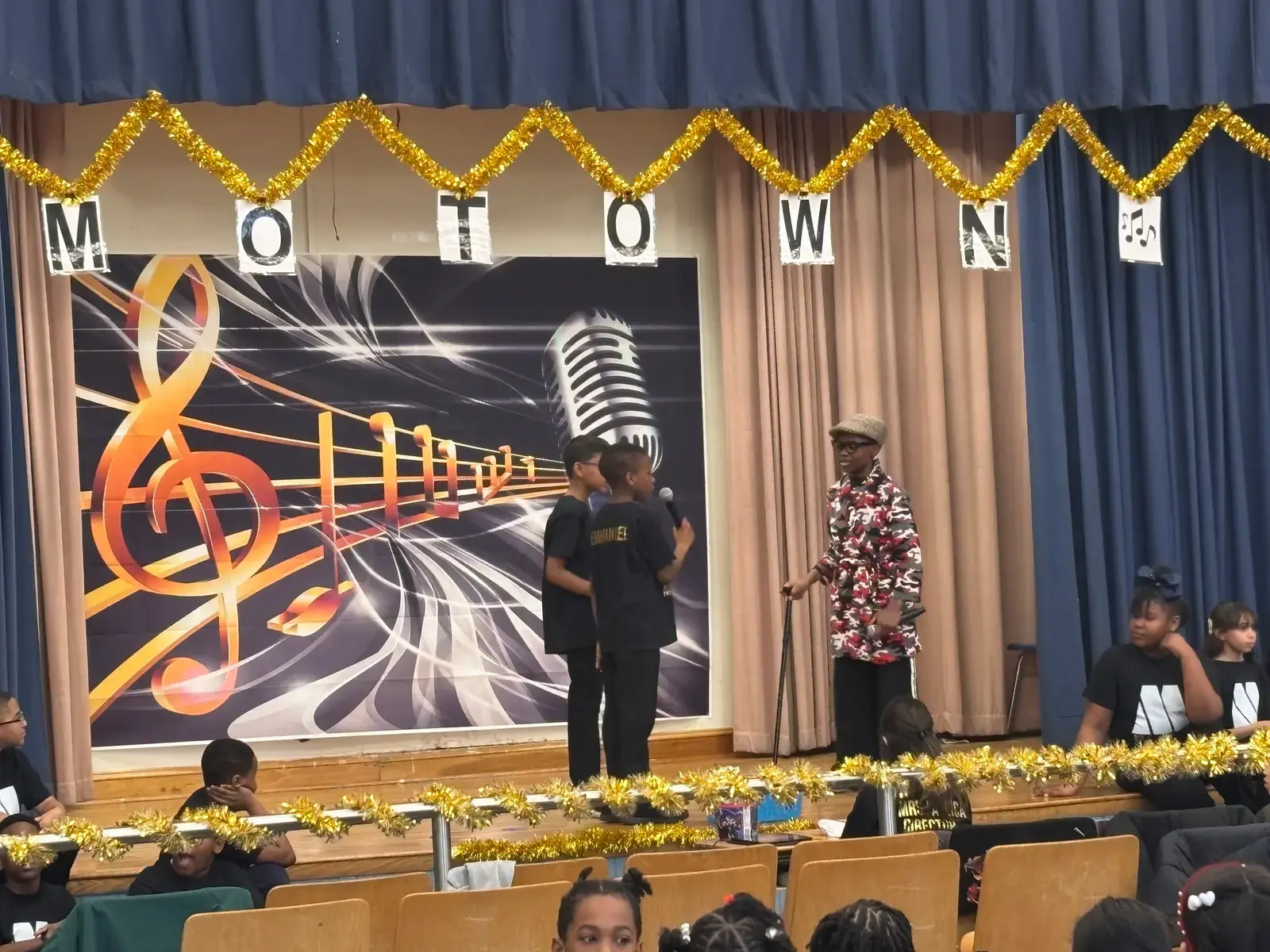 Students performing on stage at a school Motown themed program
