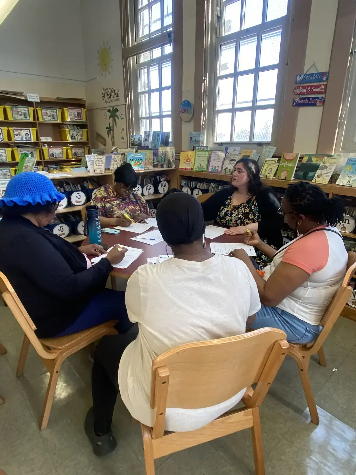 Adults meeting around a table in a school library