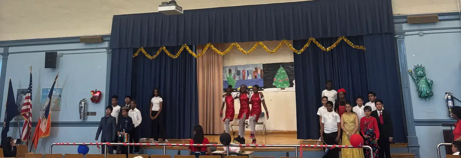Students performing in a holiday stage show in school auditorium
