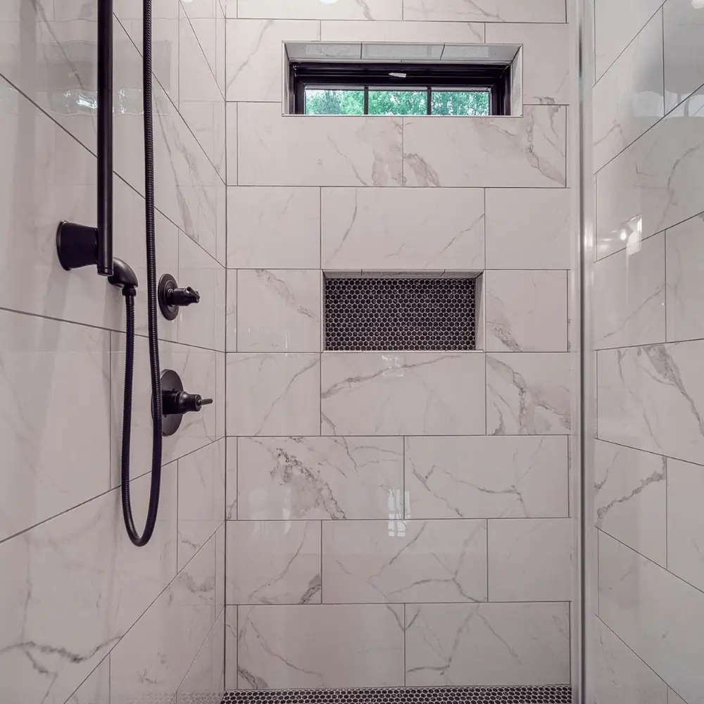 Large full tile modern shower with black accents