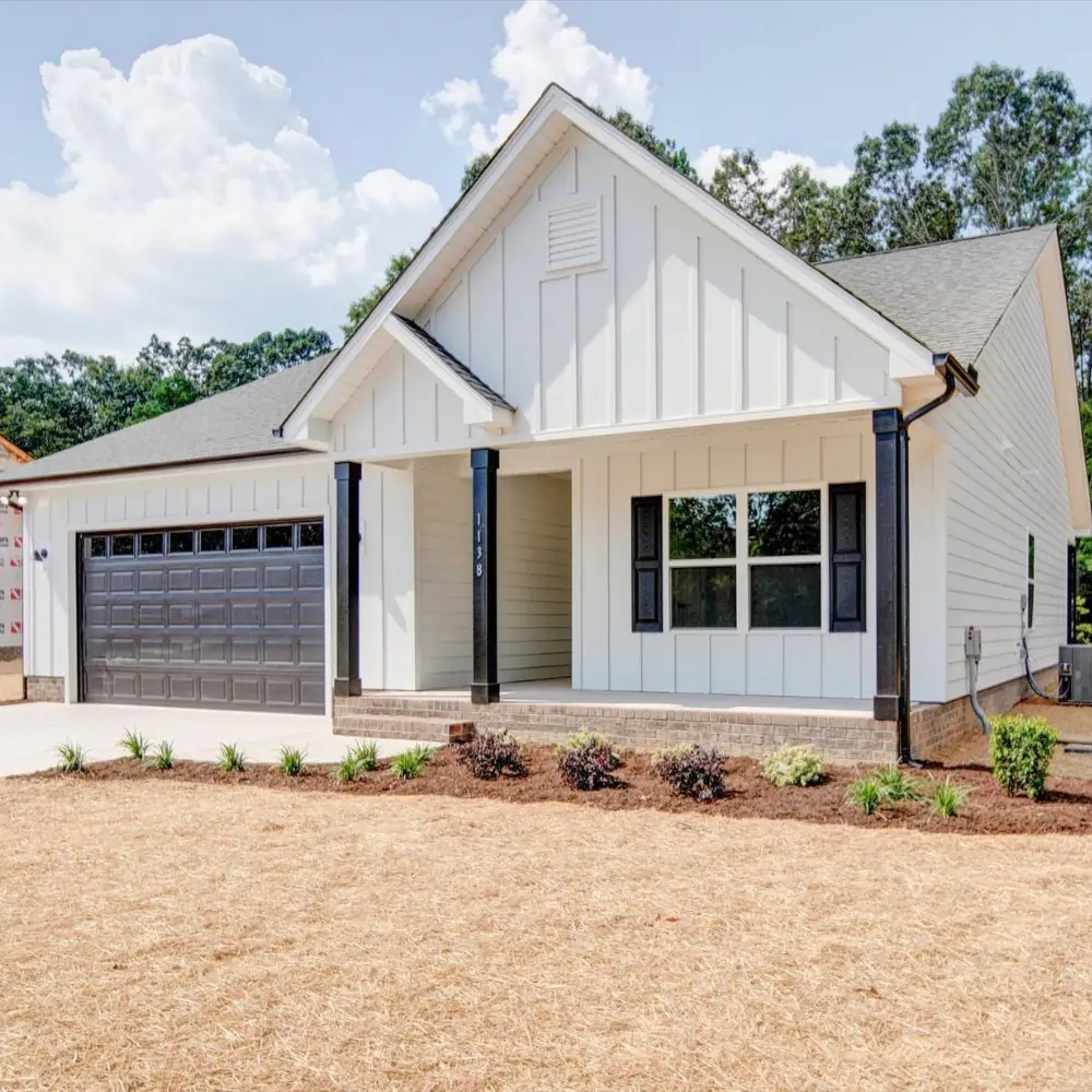 White ranch style home with hardboard siding and black modern accents.