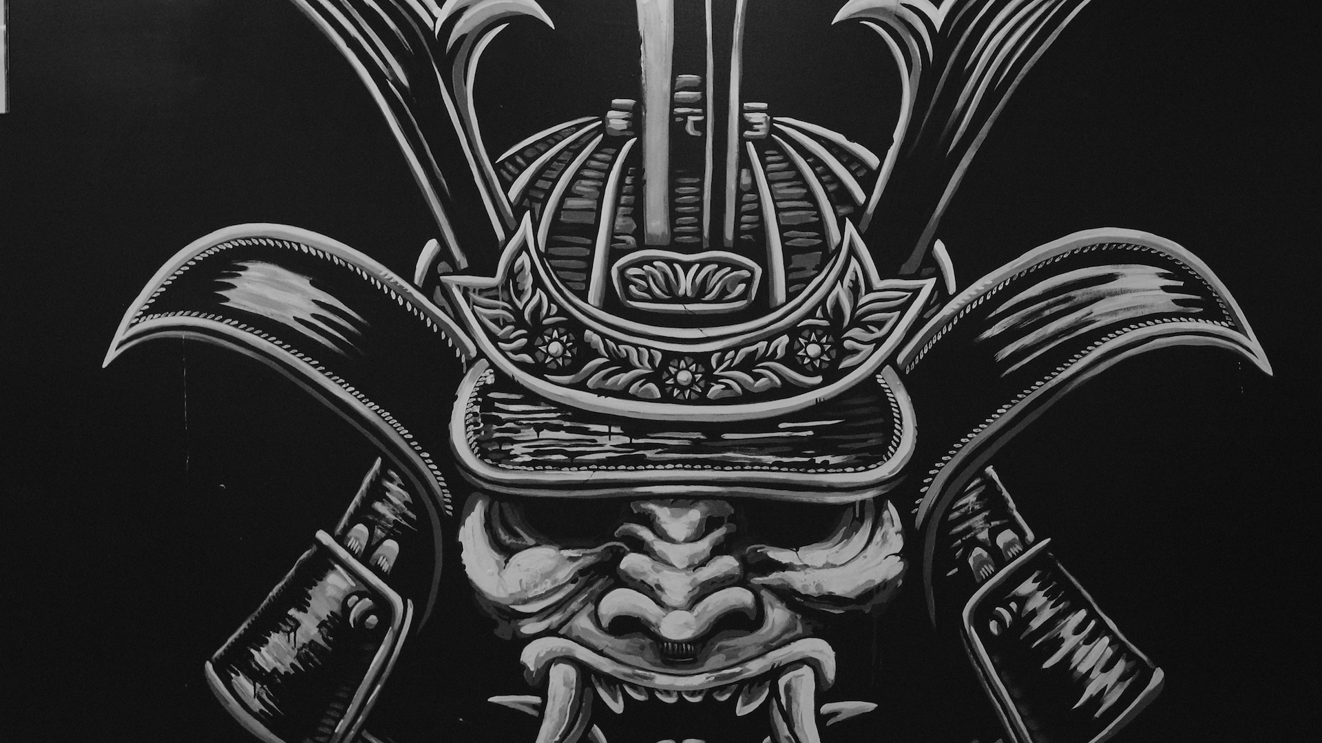 Pair of shoes hanging by their laces over a power line with a church steeple blurred in the background.