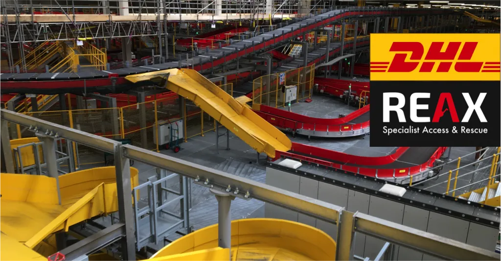 A large warehouse with winding conveyor belts, showing the DHL and REAX logo