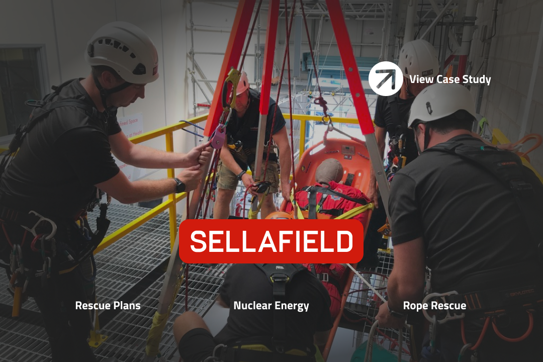 A team wearing safety equipment operating a casualty in a stretcher