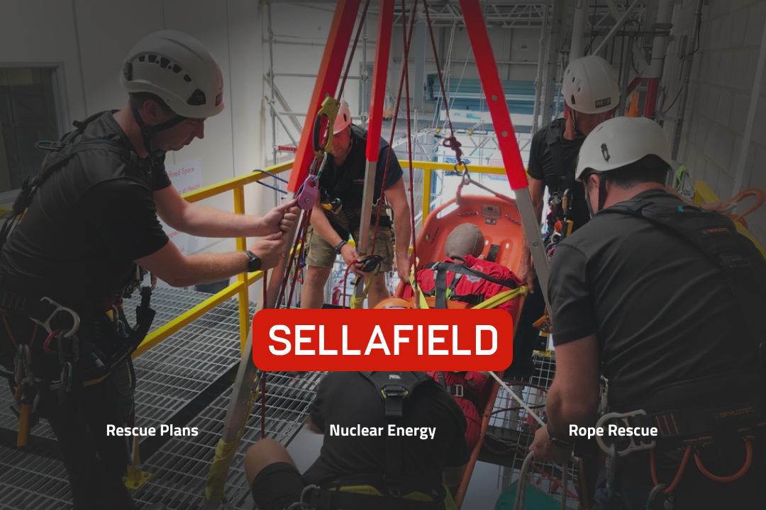 A team wearing safety equipment operating a casualty in a stretcher