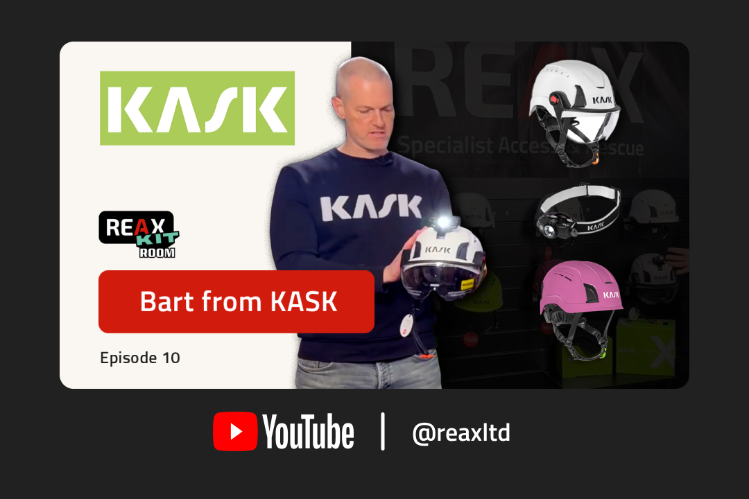 A man holding a KASK helmet with the KASK logo and helmets surrounding him