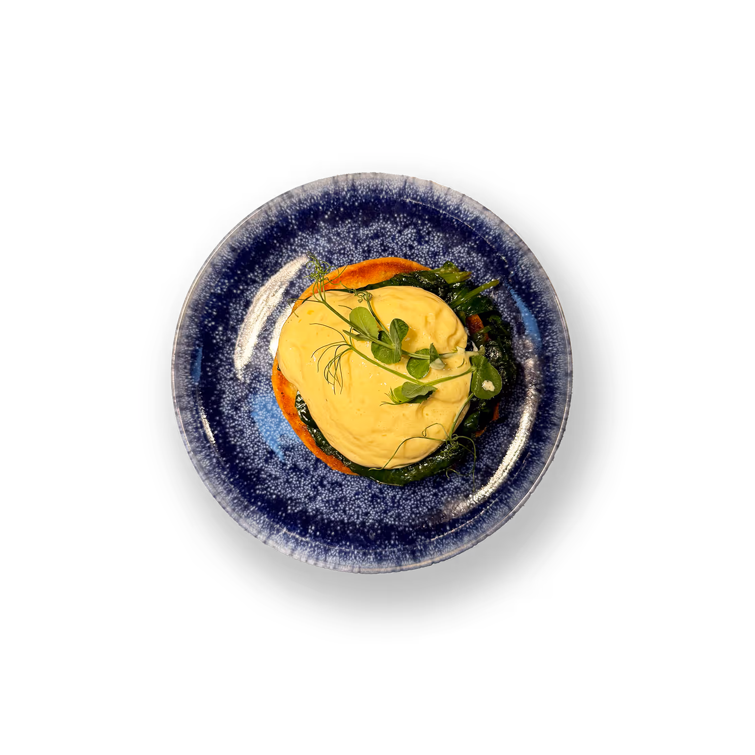 Pochiertes Bio-Ei auf Brioche Bun mit sautiertem Spinat, Sauce Hollandaise & Erbsenspargel.