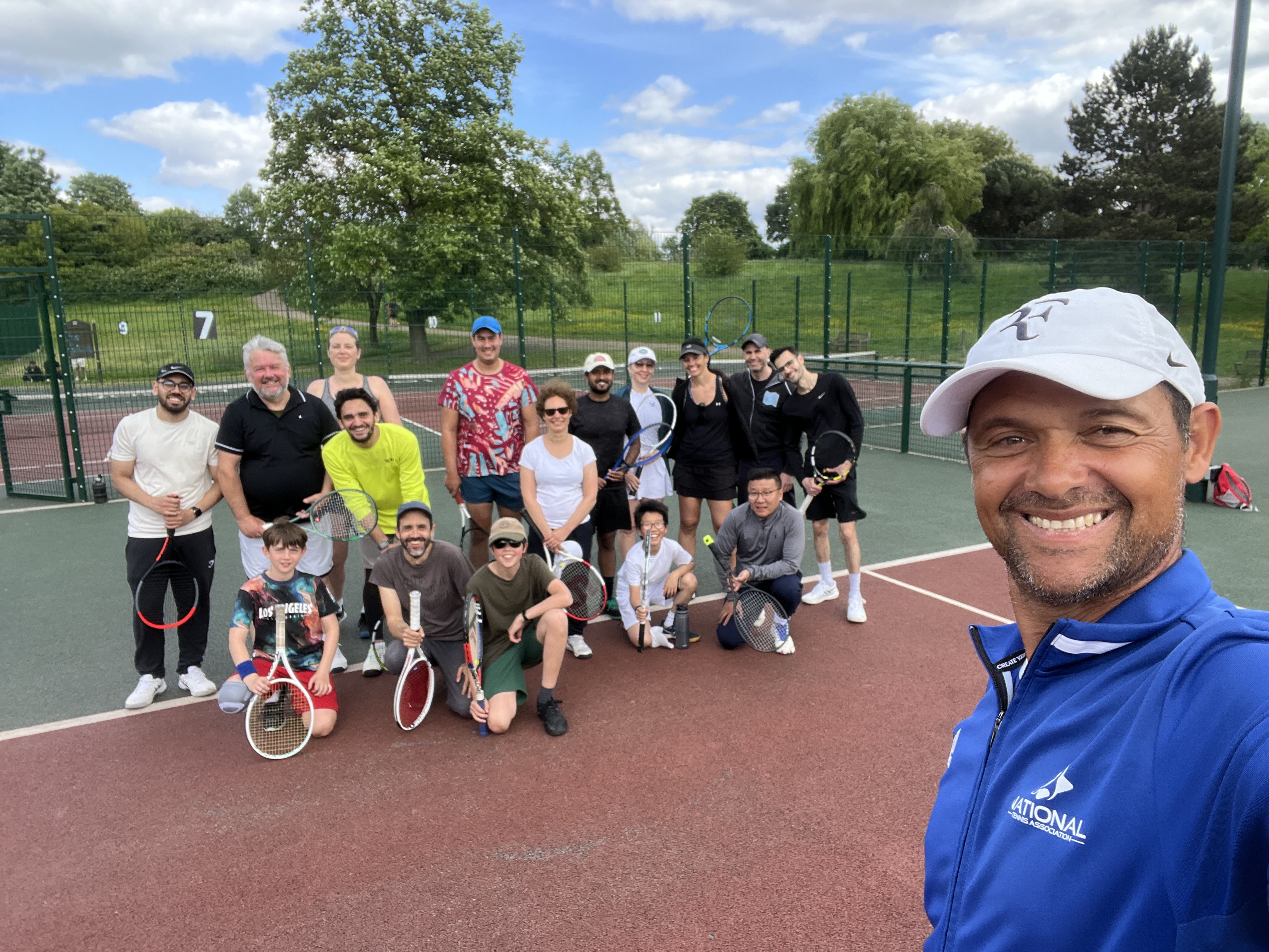 Adult group session with a National Tennis coach on a park court
