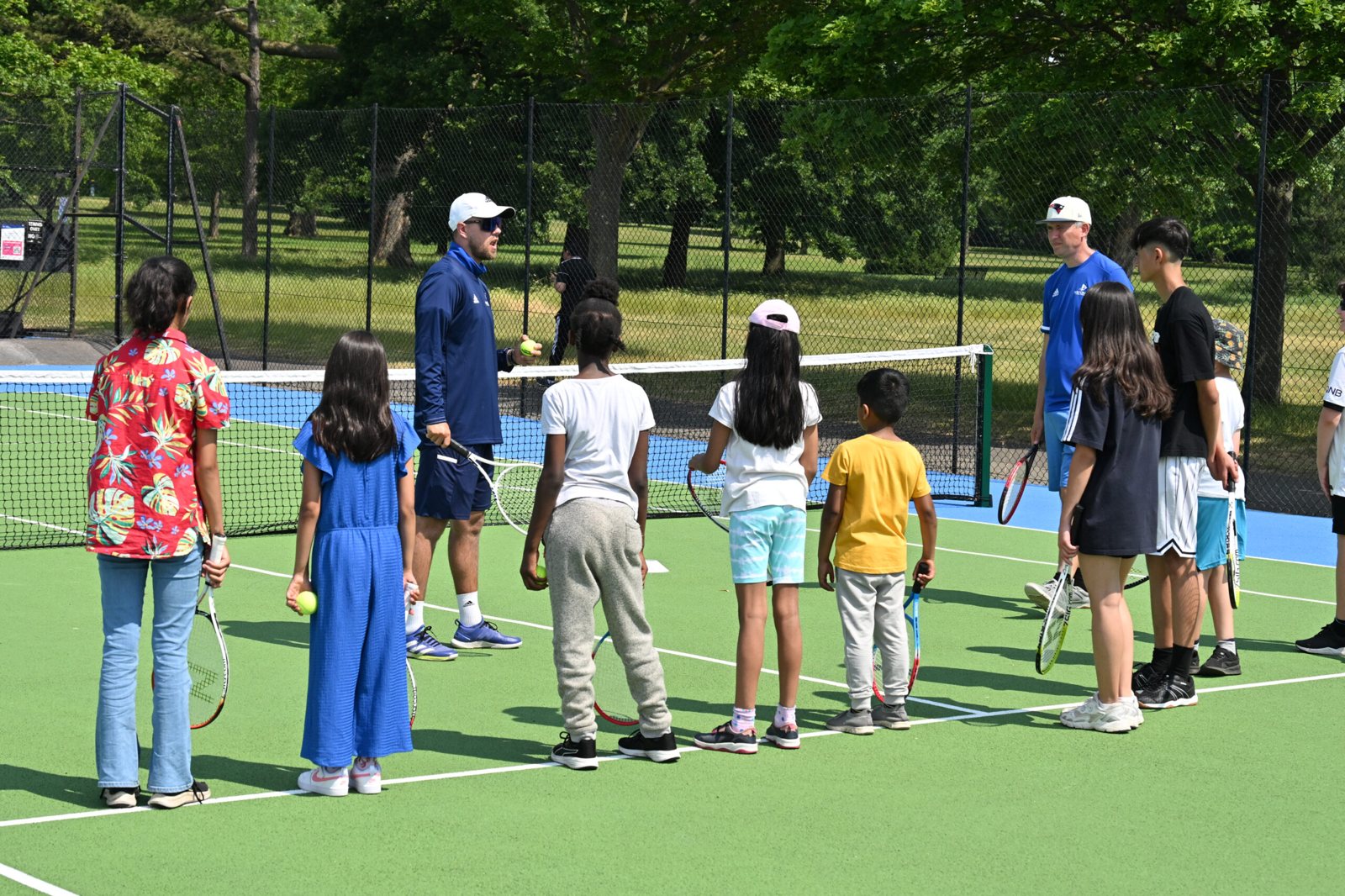 A group of children with their coaches at a National Tennis holiday camp