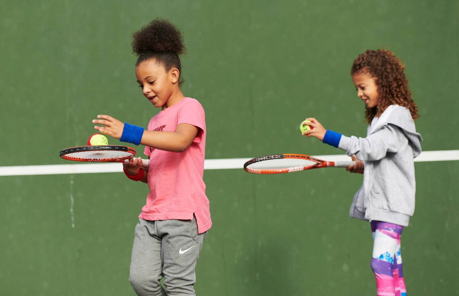Two young players practising racket and ball control