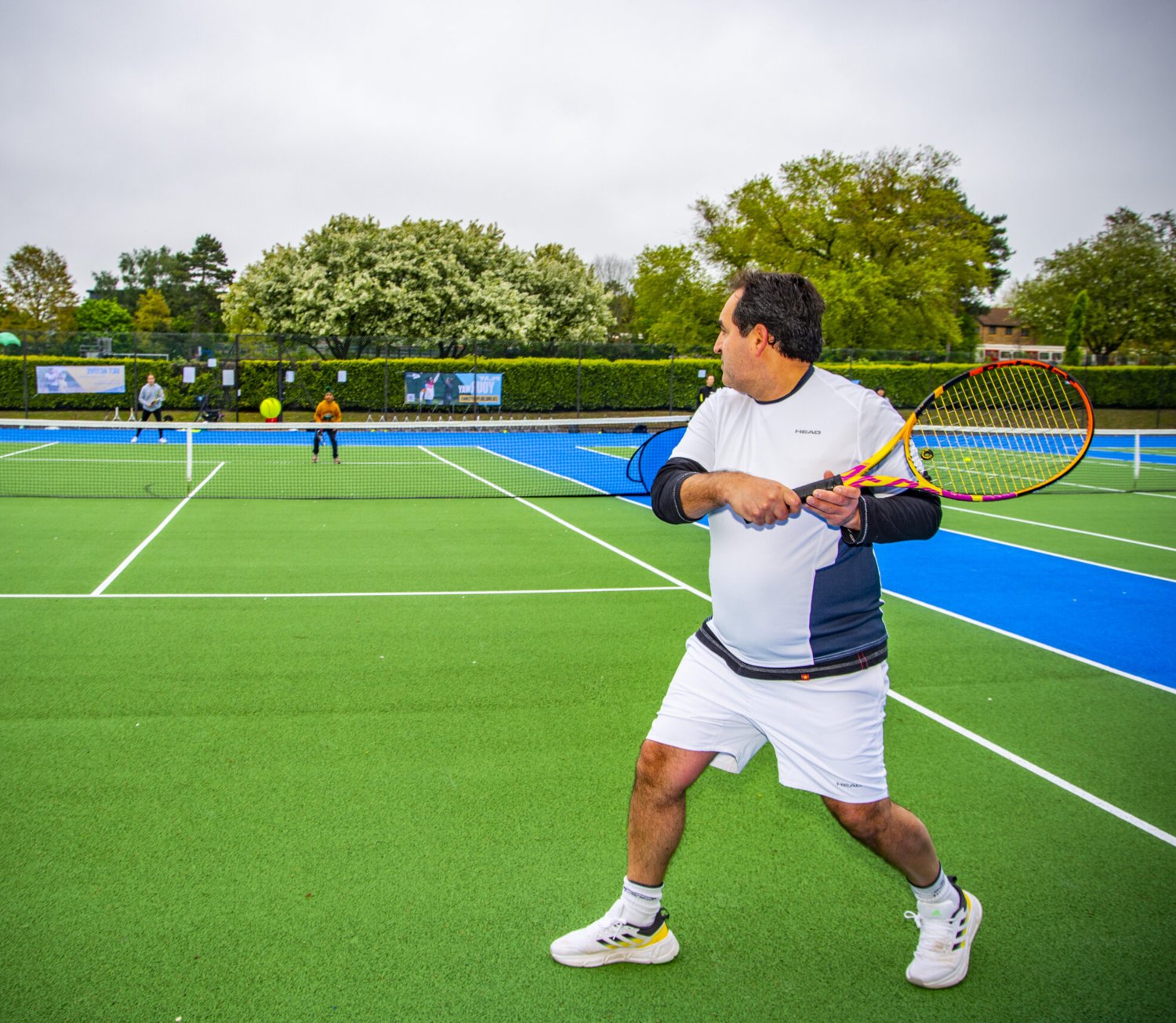 A player hitting a forehand during match play at a National Tennis event