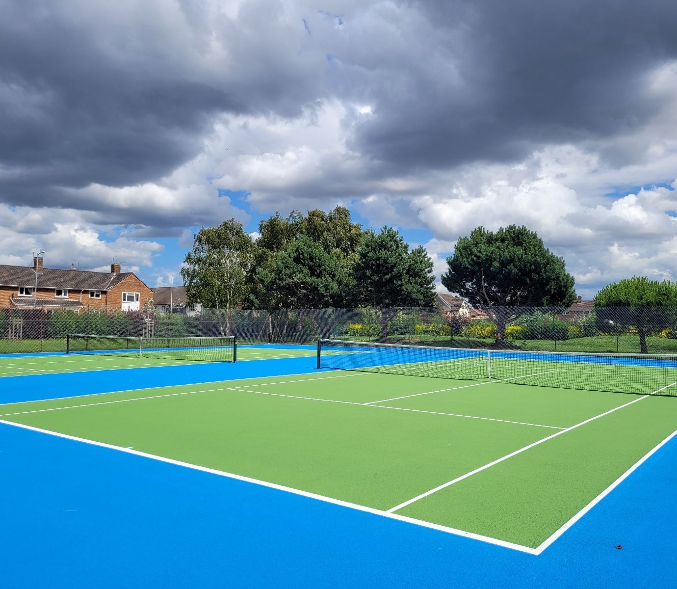 Freshly resurfaced blue and green park tennis courts