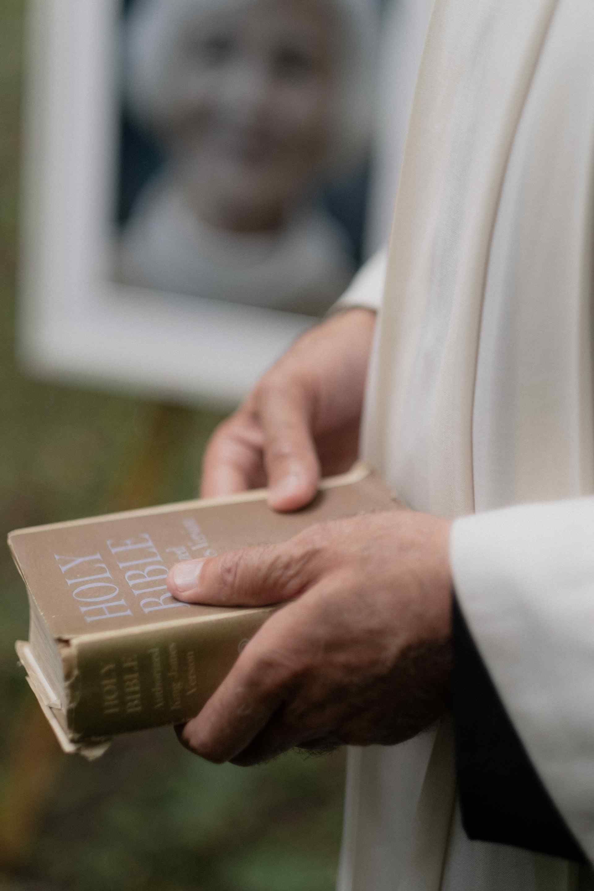 Priest holding bible