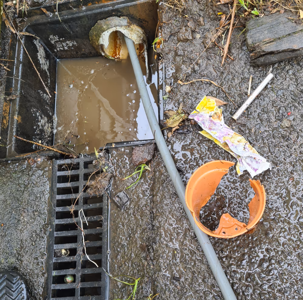 Blocked drain being cleared.