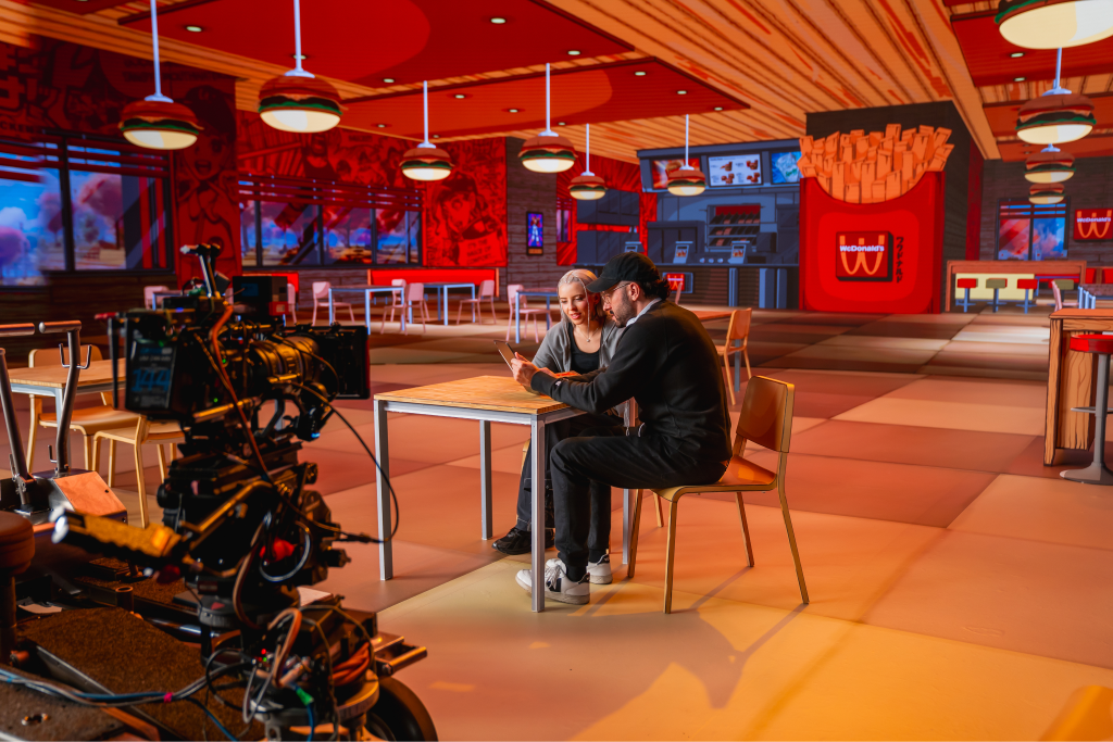 Two people talking on a mcdonalds shoot.