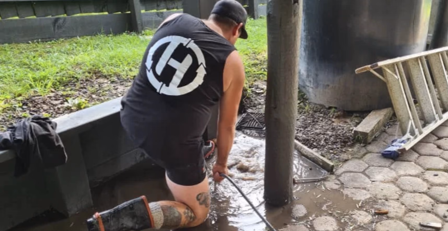 Hydro Vision technician clearing a flooded outdoor drain