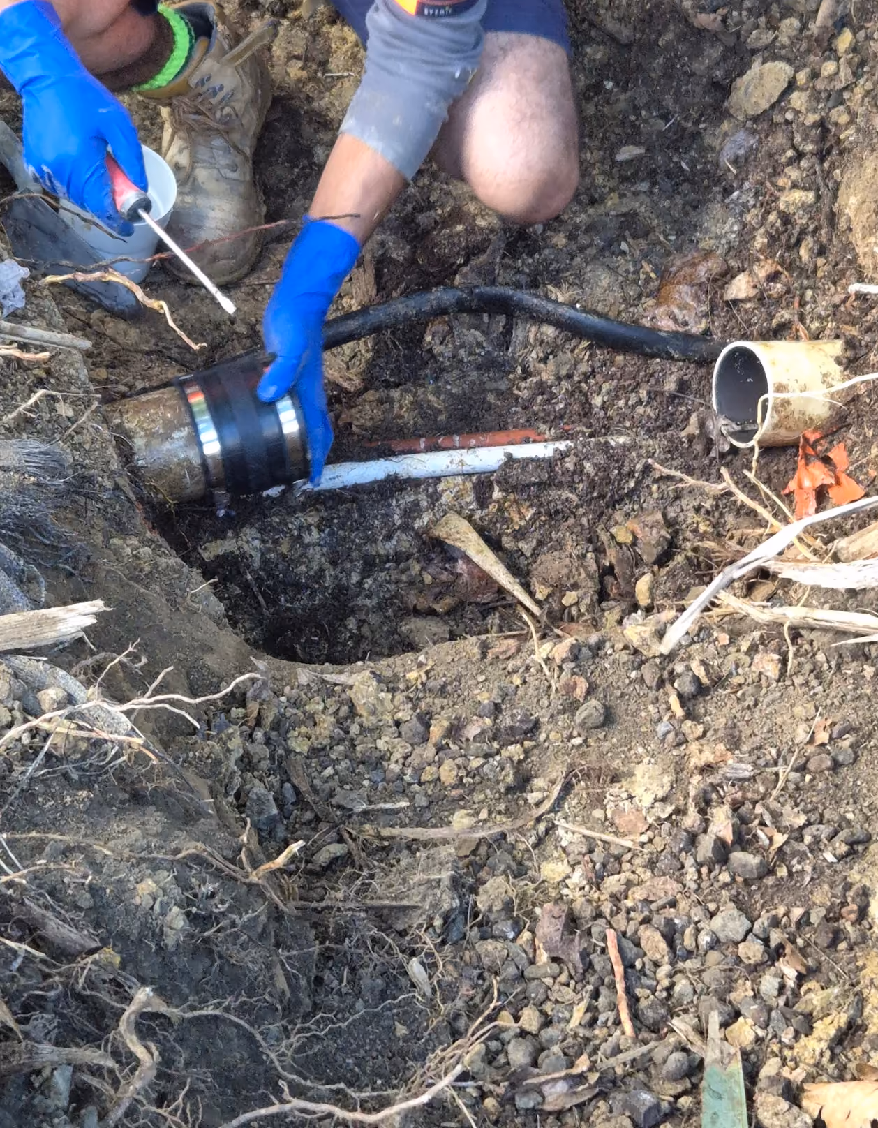 Hydro Vision technician repairing an exposed underground drain connection