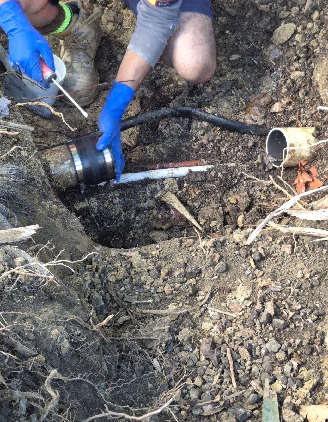 Hydro Vision technician repairing an exposed underground drain connection