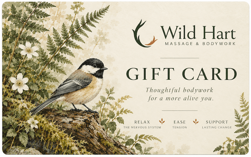 Wild Hart gift card with a chickadee resting on a moss-covered branch among ferns and woodland flowers.