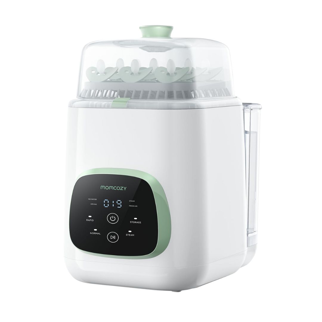 A white, rectangular all-in-one baby bottle washer, sterilizer, and dryer with a digital display, shown on a kitchen counter.
