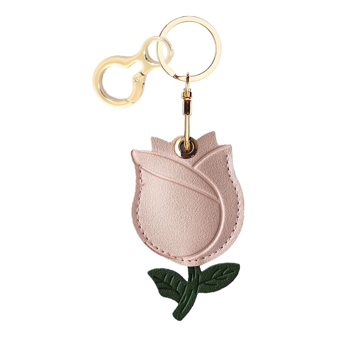 A leather keychain holder case for AirTag, featuring a secure ring and a protective cover with various cute designs.