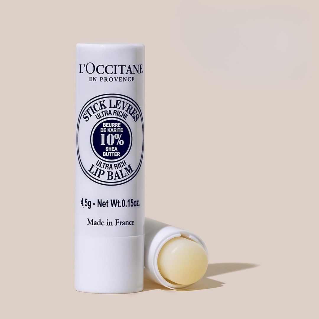 A twist-up lip balm stick with a white tube and cap, labeled for moisturizing and repairing dry lips.