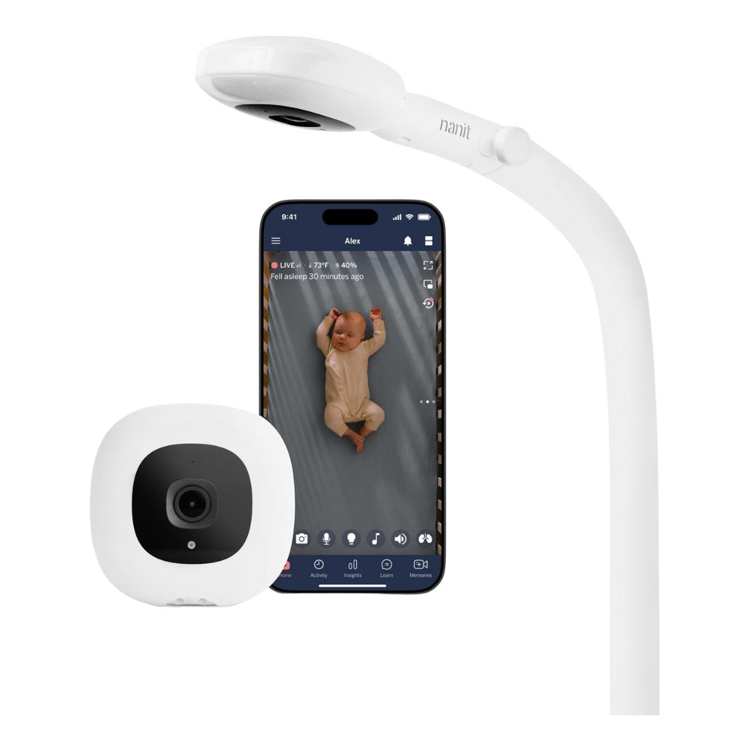 A white baby monitor camera on a floor stand, with a slim, modern design, set up in a nursery.