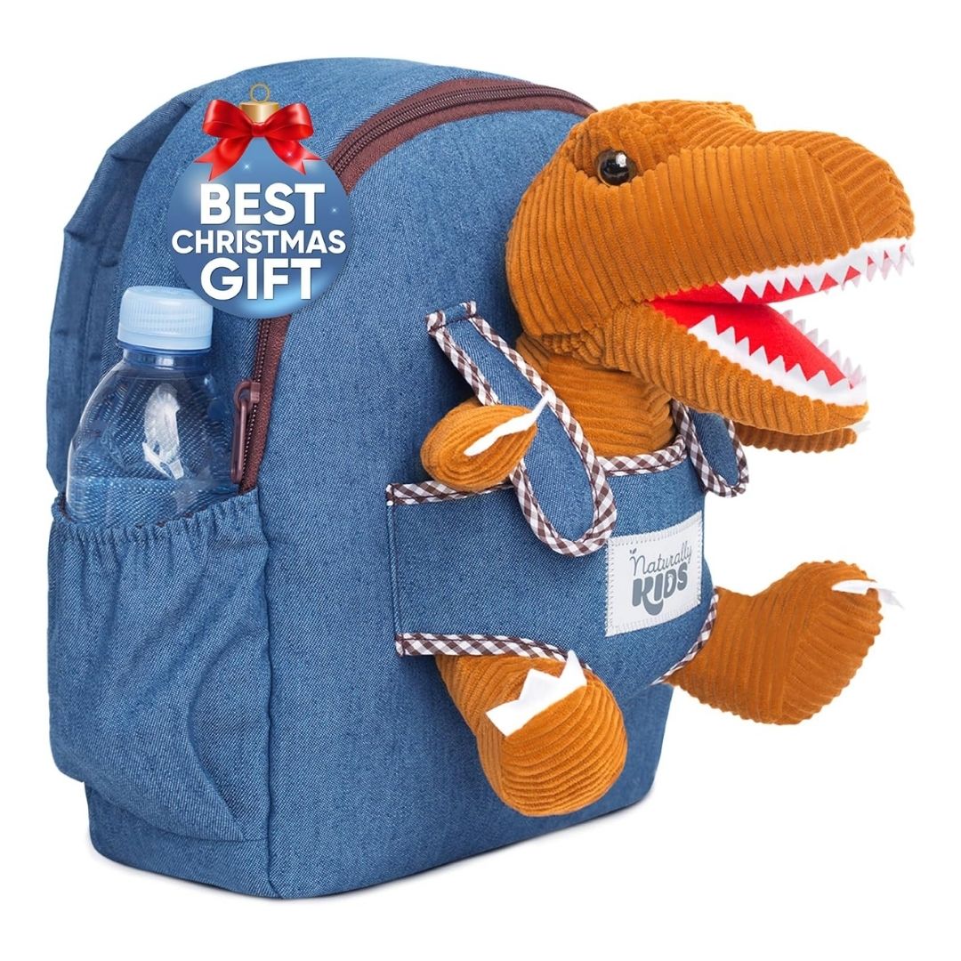 A toddler backpack with padded straps and a sturdy zipper, featuring a removable T-Rex stuffed animal on the front.