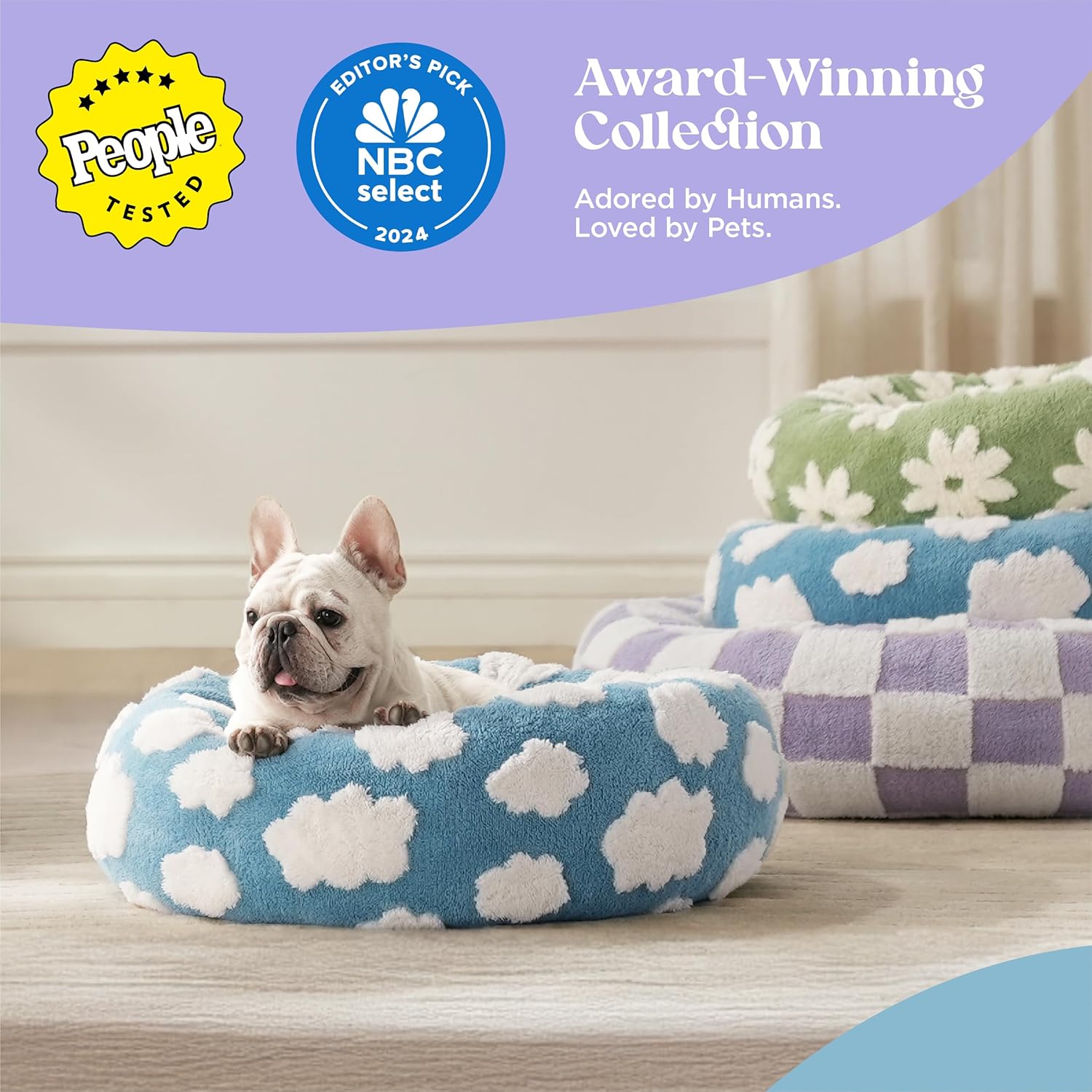 A round, plush donut-shaped pet bed with raised bolstered edges, soft shaggy fabric, and an anti-slip bottom, shown in a modern indoor setting.