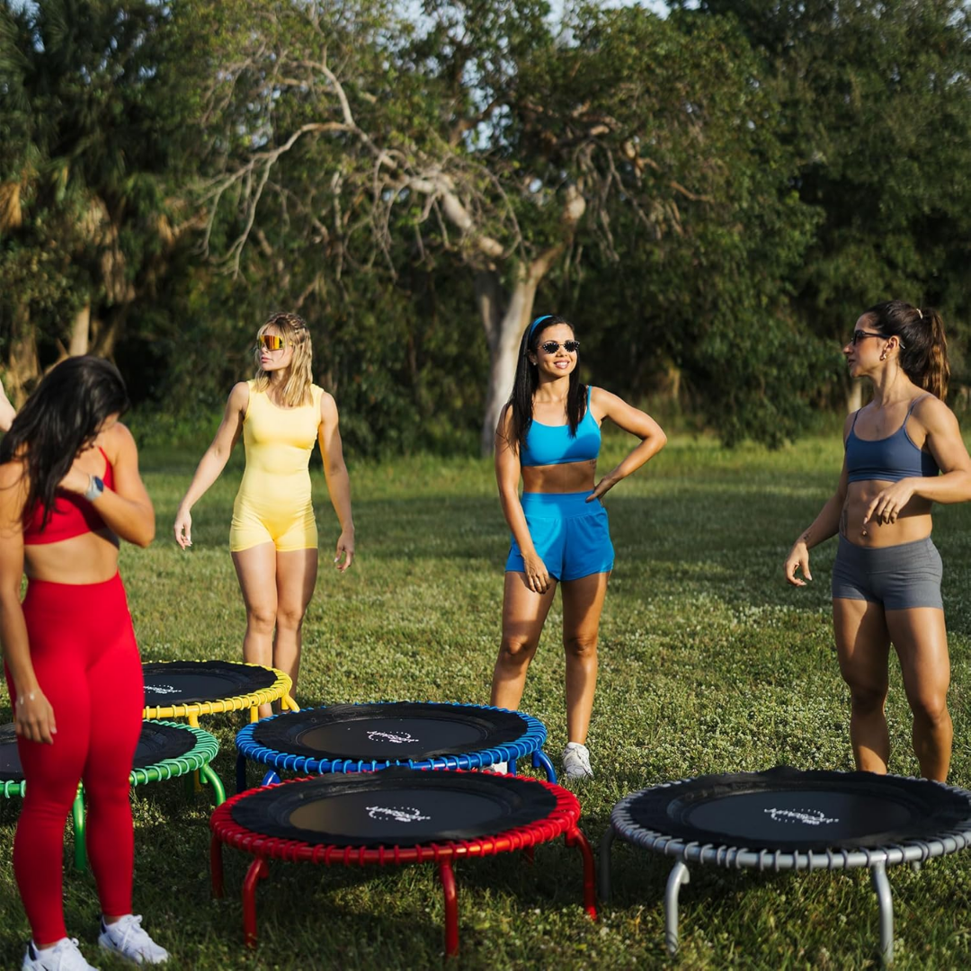 A round fitness trampoline with a sturdy steel frame, arched legs, and a black mat, designed for home cardio workouts.