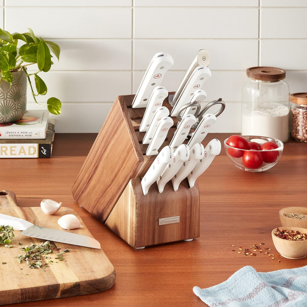 A kitchen knife block set with multiple stainless steel knives, shears, and a honing steel in a wooden block, available in white or black.