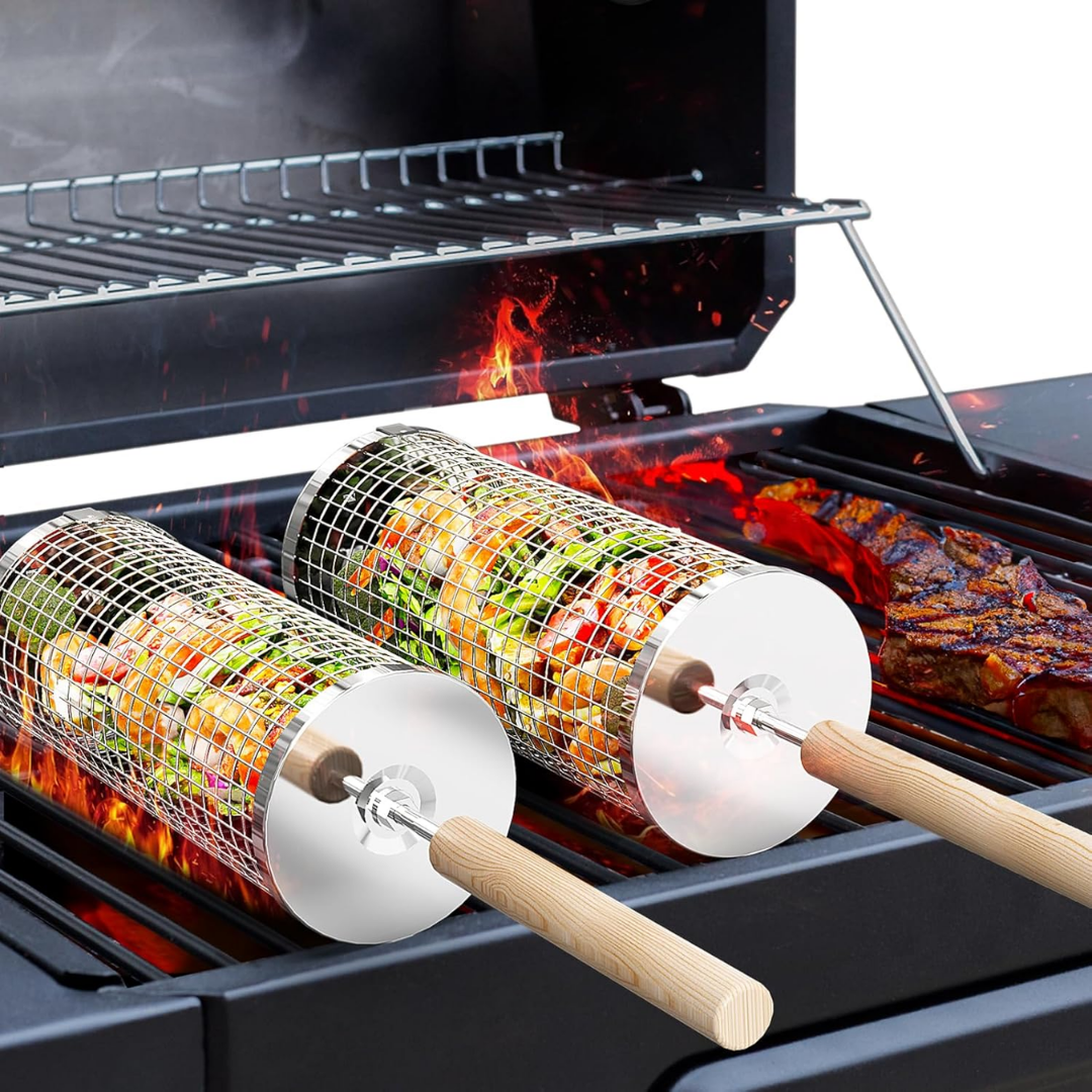 A stainless steel rolling grill basket with a removable wooden handle, shown nested for compact storage, ideal for grilling vegetables outdoors.