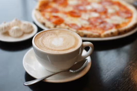 A coffee and a pizza at a restaurant