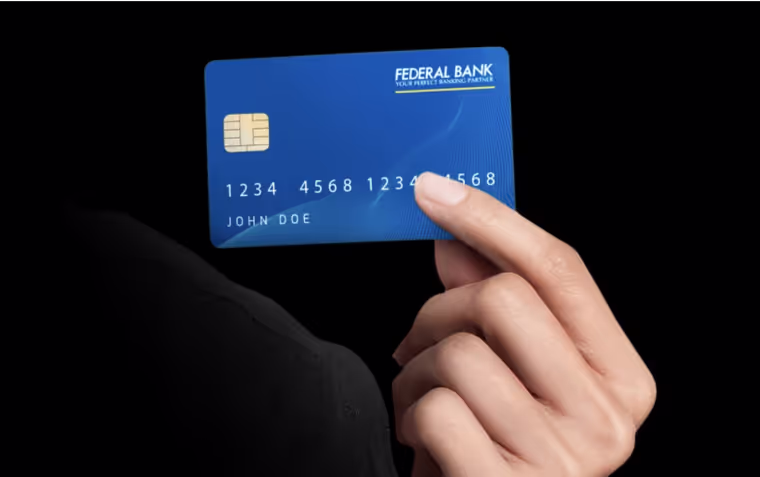 A woman holding a credit card in her hand.