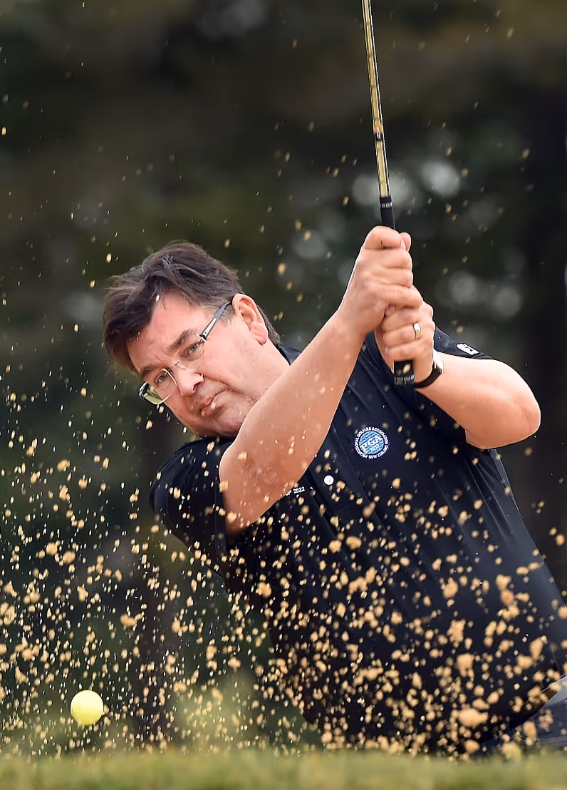 Andrew Whiley playing golf.