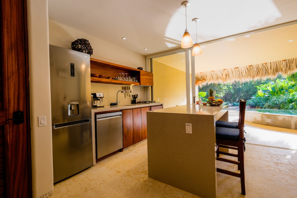 Fully stocked kitchen opening onto the patio