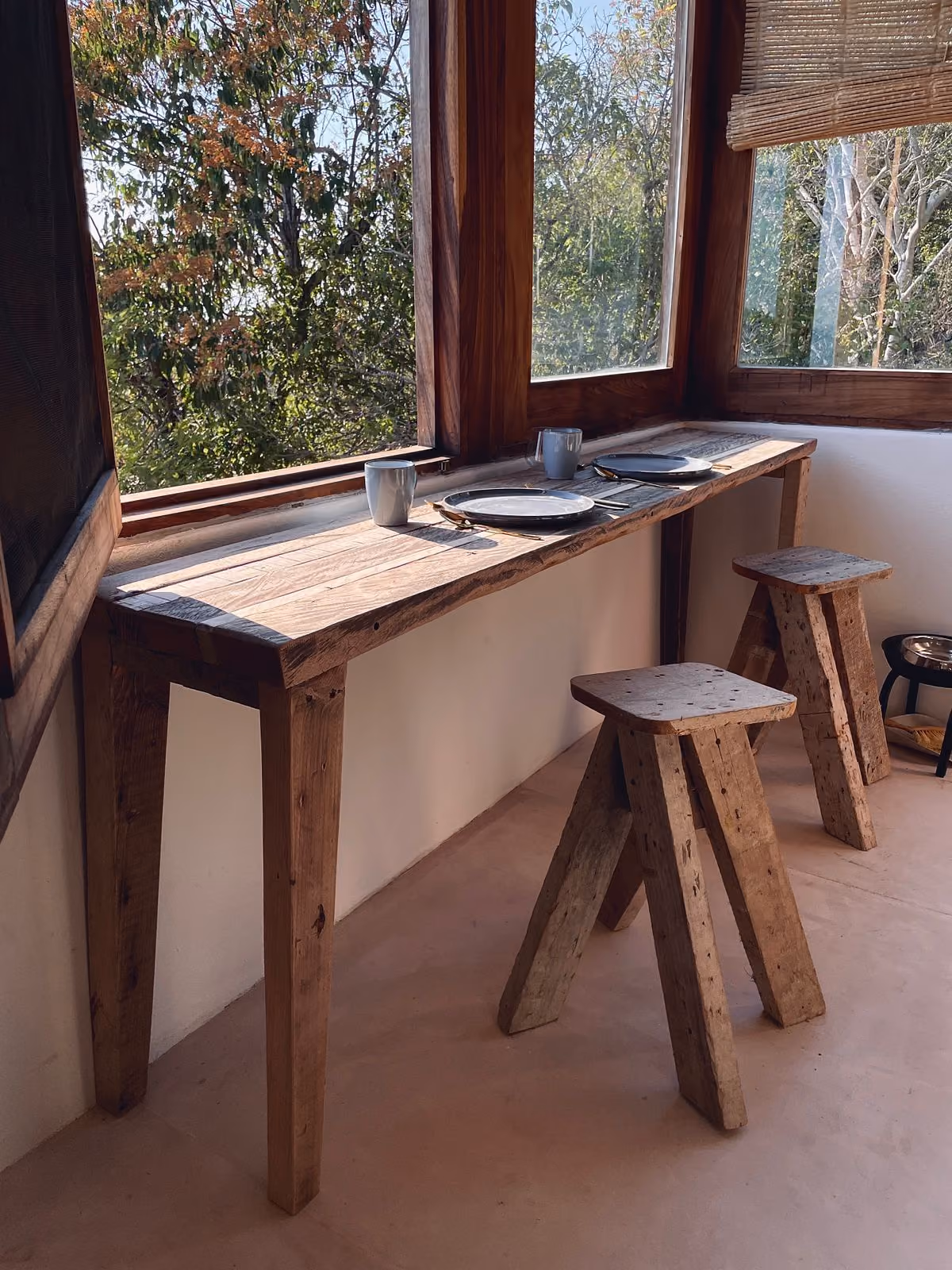 Wooden console and stools by the window