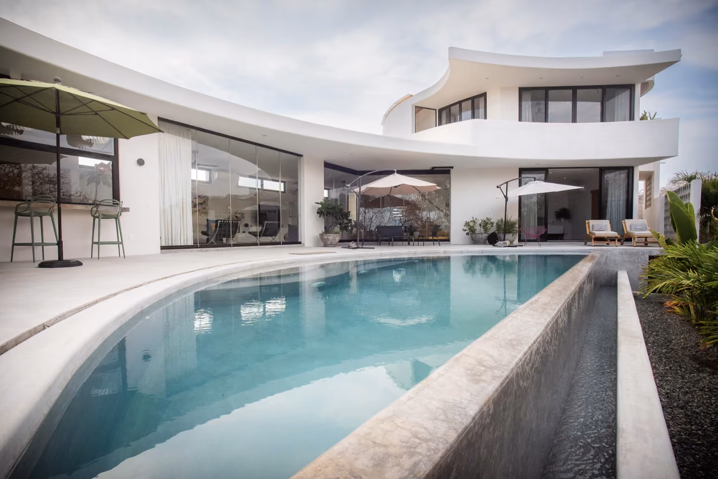 Saltwater pool and curved white architecture at La Cuna, Troncones