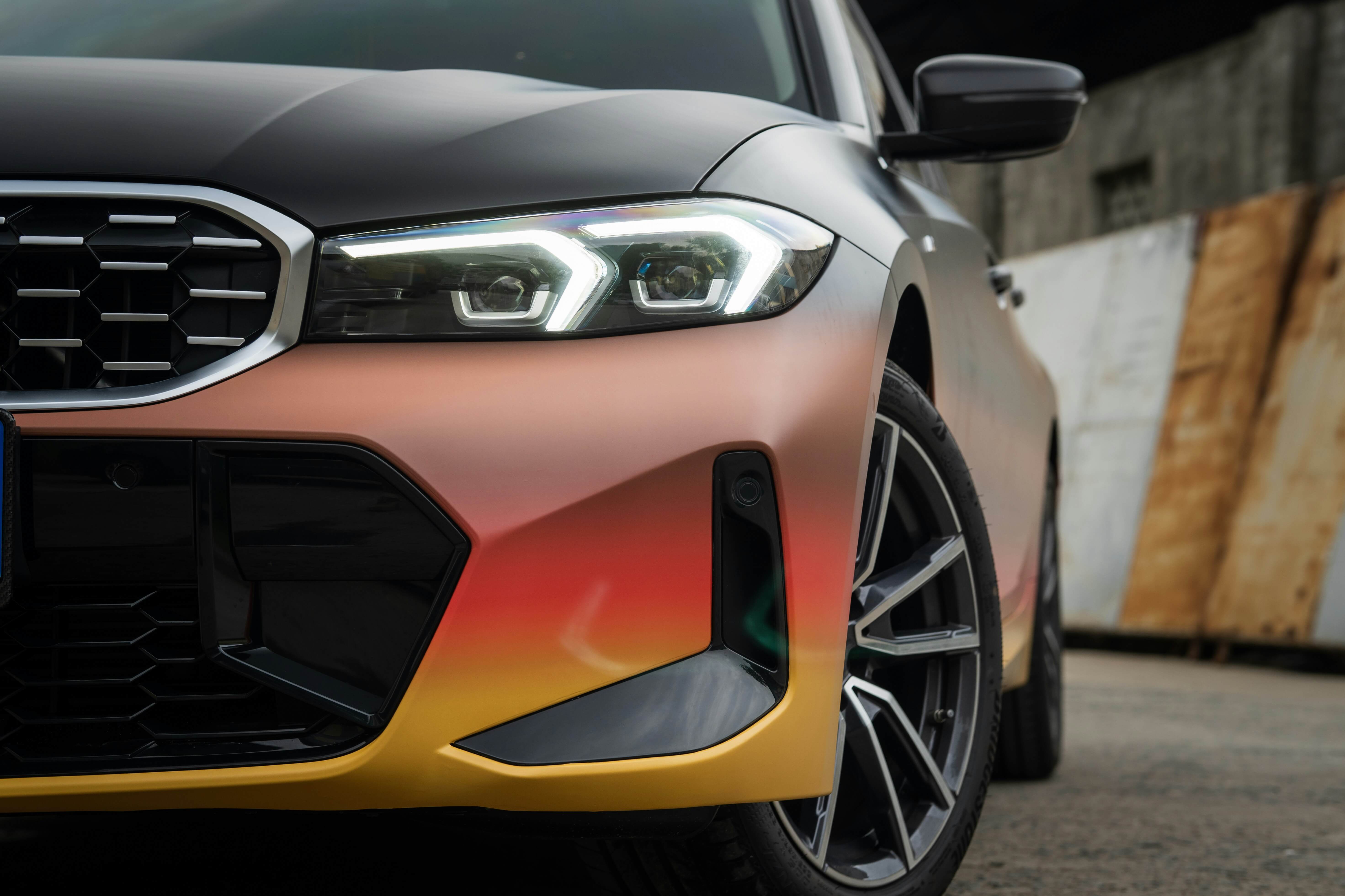 photo of a BMW car with orange-yellow ombre wrap