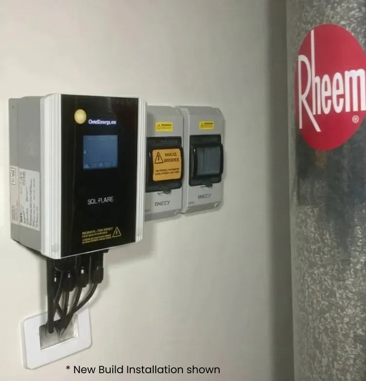 Wall-mounted solar power inverter and electrical switches next to a Rheem water heater tank.